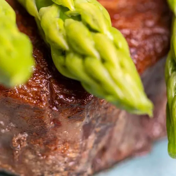 Pink lamb Shank with asparagus Served lamb shank in the menu